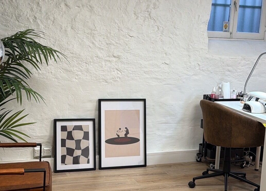 Stylish salon corner at June Studios, Edinburgh, Scotland, GB with plants and framed art.