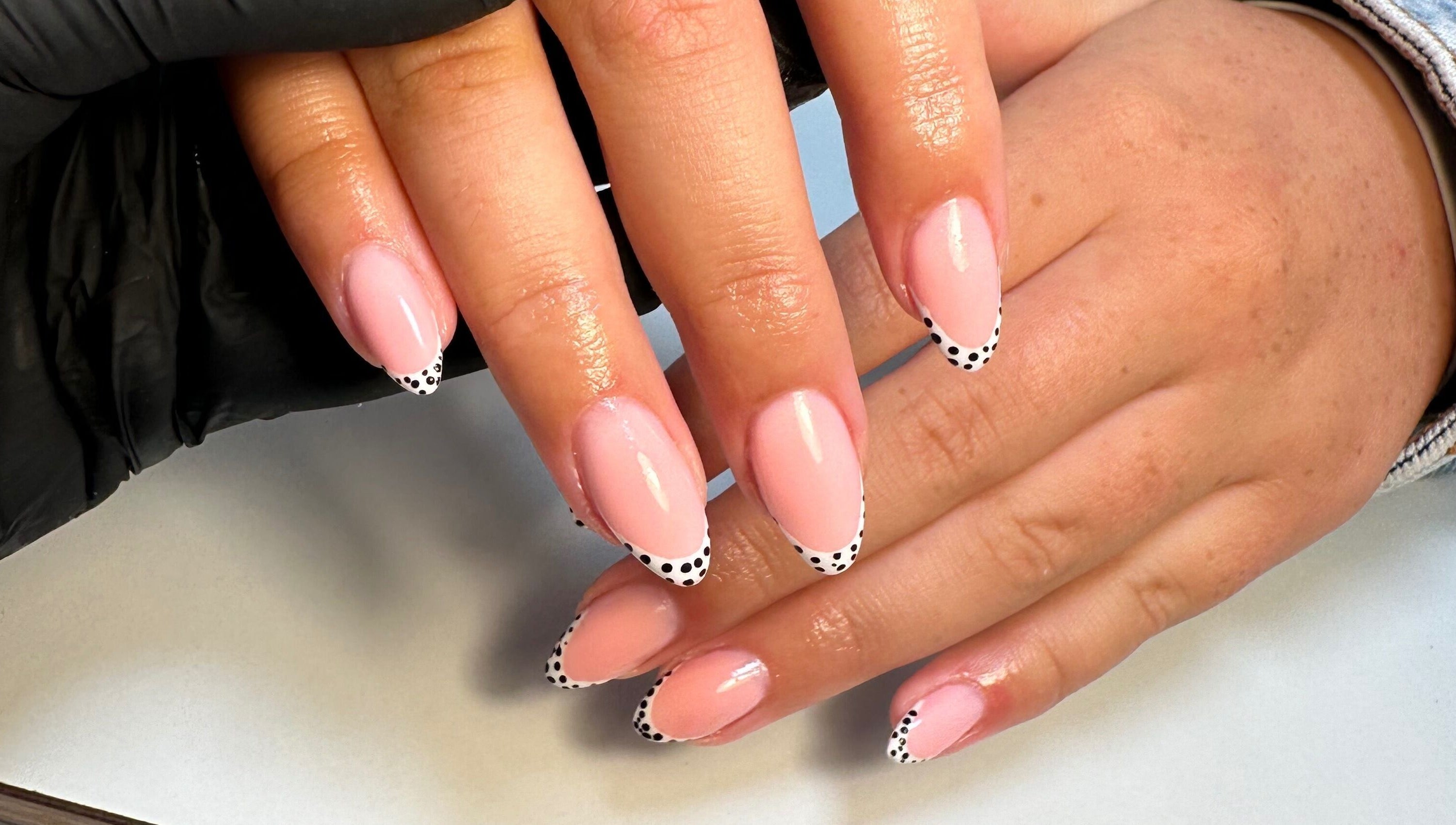 Elegant pink nails with polka dot tips at Classyclaws, Dublin, County Dublin, IE.