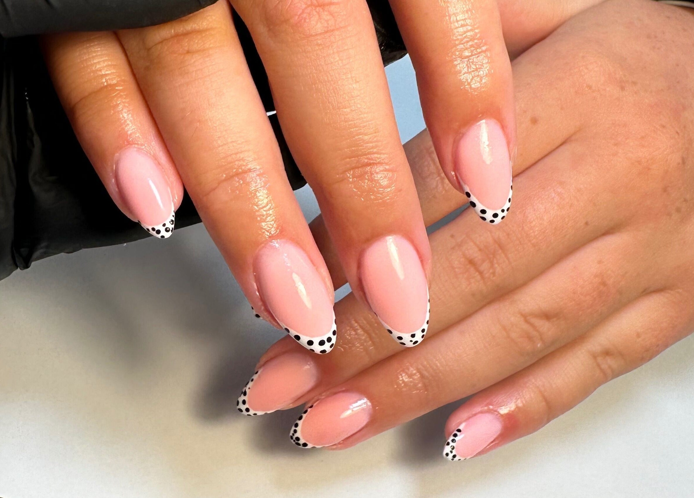 Elegant pink nails with polka dot tips at Classyclaws, Dublin, County Dublin, IE.