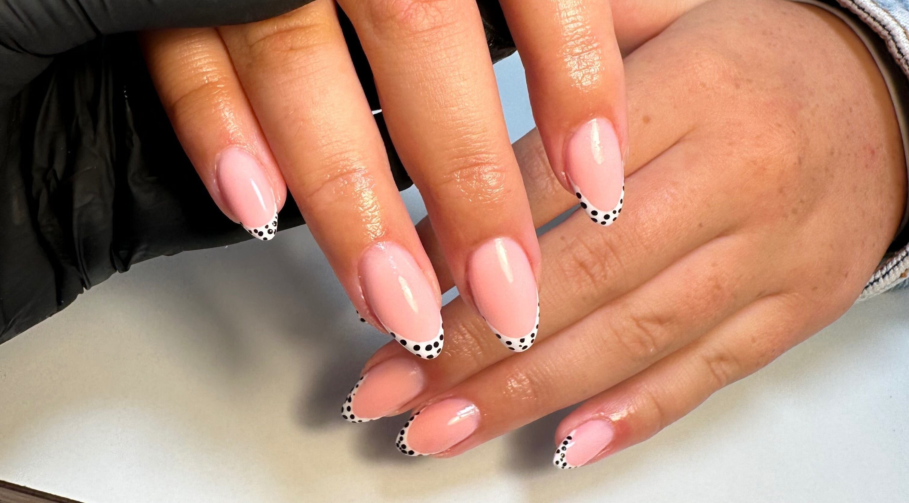 Elegant pink nails with polka dot tips at Classyclaws, Dublin, County Dublin, IE.