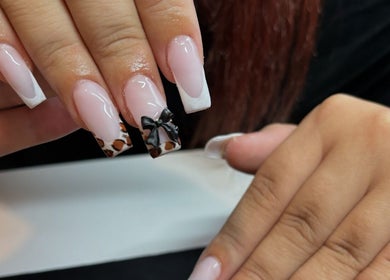 Elegant nail design with bow and leopard print at Belsbeautybarx, Birmingham, England, GB.