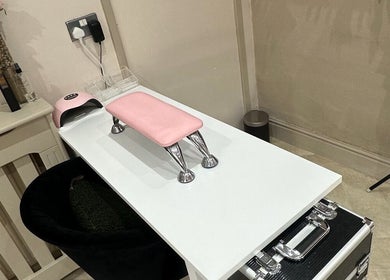 Manicure station with pink cushioned rest at Belsbeautybarx, Birmingham, England, GB.