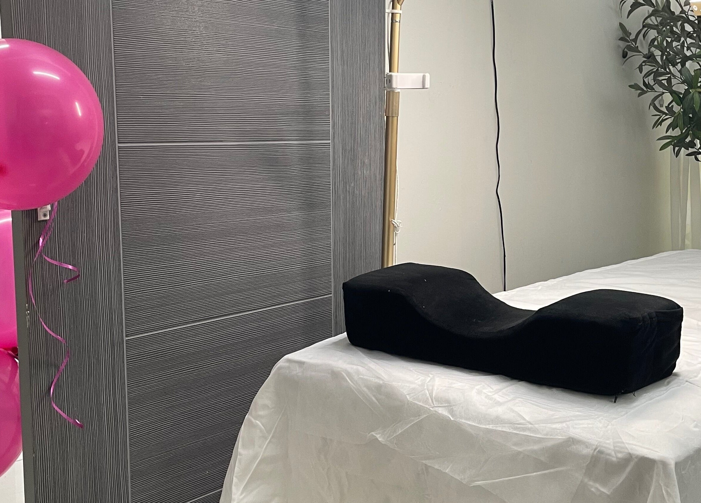 Treatment room at Donna Marie Skin Pharm in Old Harbour, St. Catherine Parish with balloons and massage table.