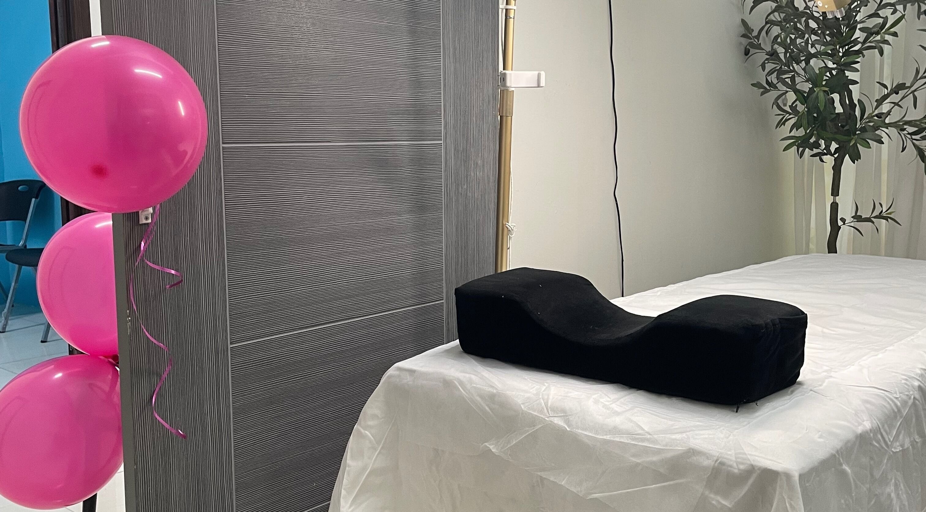 Treatment room at Donna Marie Skin Pharm in Old Harbour, St. Catherine Parish with balloons and massage table.