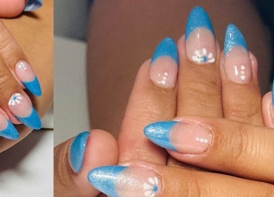 Stylish blue French manicure at Nailstalgic✨ in Lubbock, Texas, US, featuring floral accents.