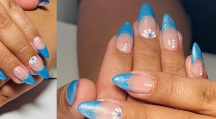 Stylish blue French manicure at Nailstalgic✨ in Lubbock, Texas, US, featuring floral accents.