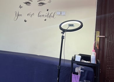 Beauty room at Her_essentialz.ng in Lagos, Lagos, NG, featuring a makeup light and wall art.