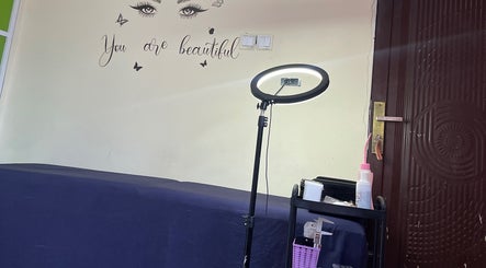 Beauty room at Her_essentialz.ng in Lagos, Lagos, NG, featuring a makeup light and wall art.