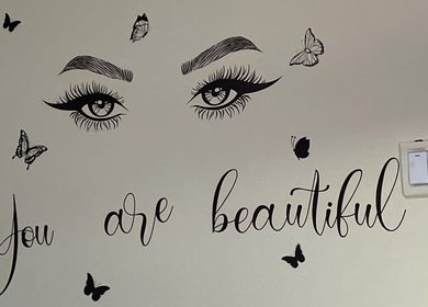 Wall art at Her_essentialz.ng in Lagos, Lagos, NG featuring eyes, butterflies, and text 'You are beautiful'.