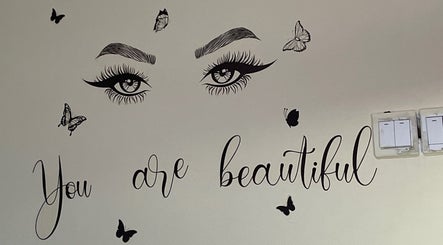 Wall art at Her_essentialz.ng in Lagos, Lagos, NG featuring eyes, butterflies, and text 'You are beautiful'.
