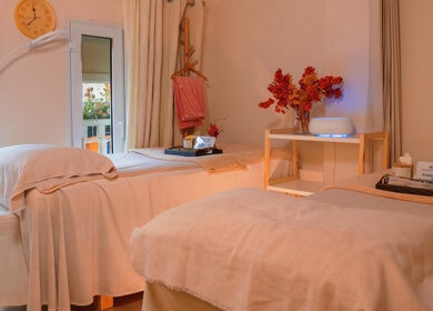 Tranquil treatment room at Caballe.M Spa, Singapore, SG, featuring cozy beds and soothing decor.