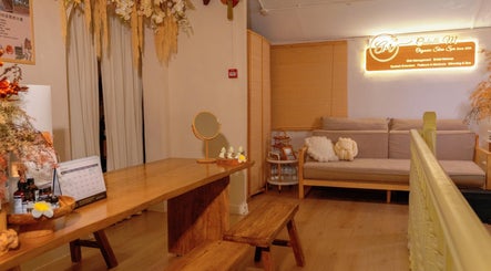 Cozy interior of Caballe.M Organic Skin Spa - Toa Payoh, Singapore, SG featuring a wooden desk, soft lighting, and seating.