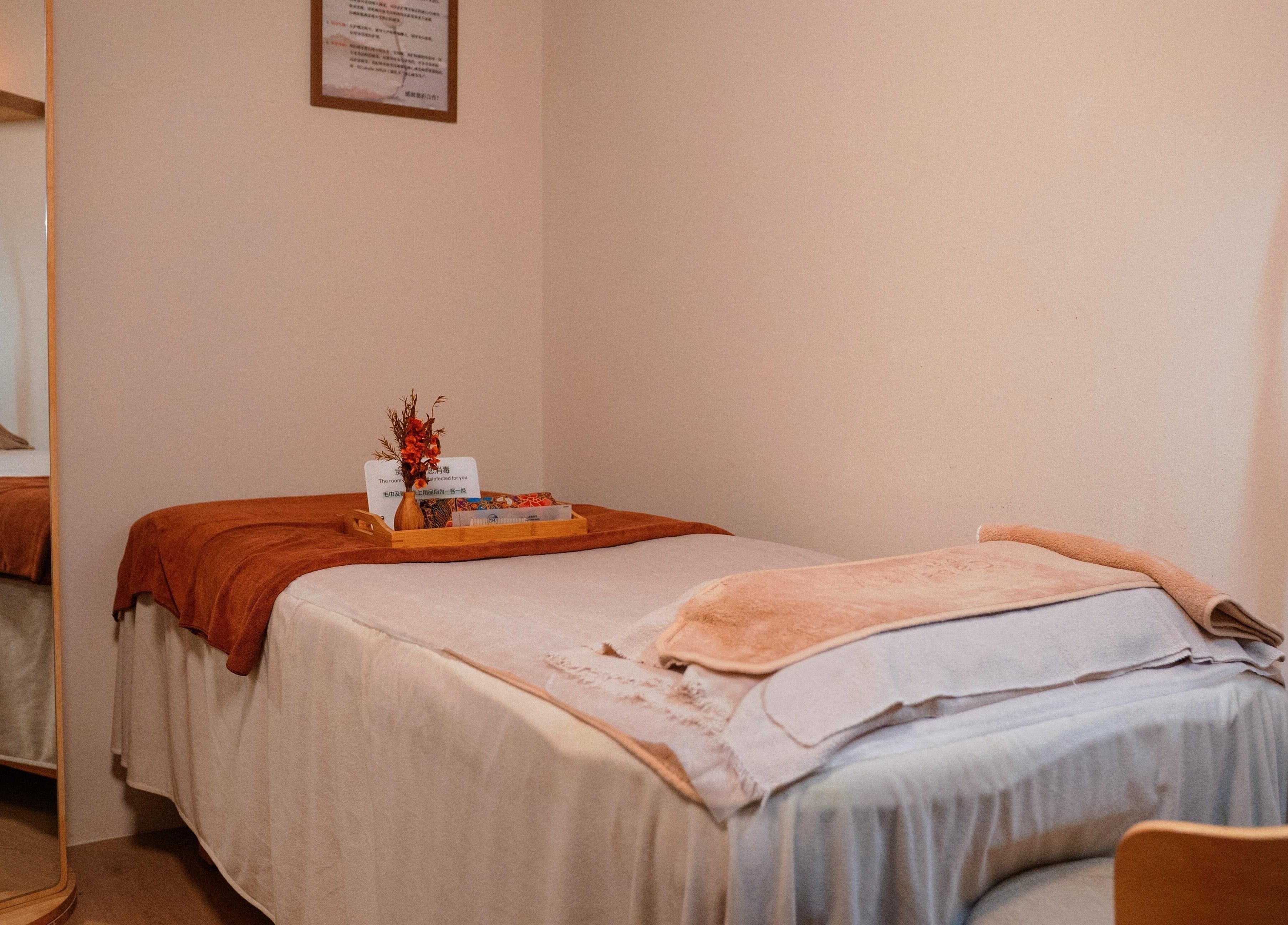Relaxing treatment room at Caballe.M Organic Skin Spa - Toa Payoh, Singapore, SG, featuring cozy bed and warm decor.