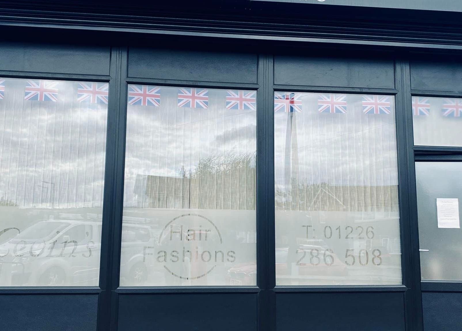 Exterior of Leopard Luxe Nails, Barnsley, England, GB, with Union Jack flags displayed.