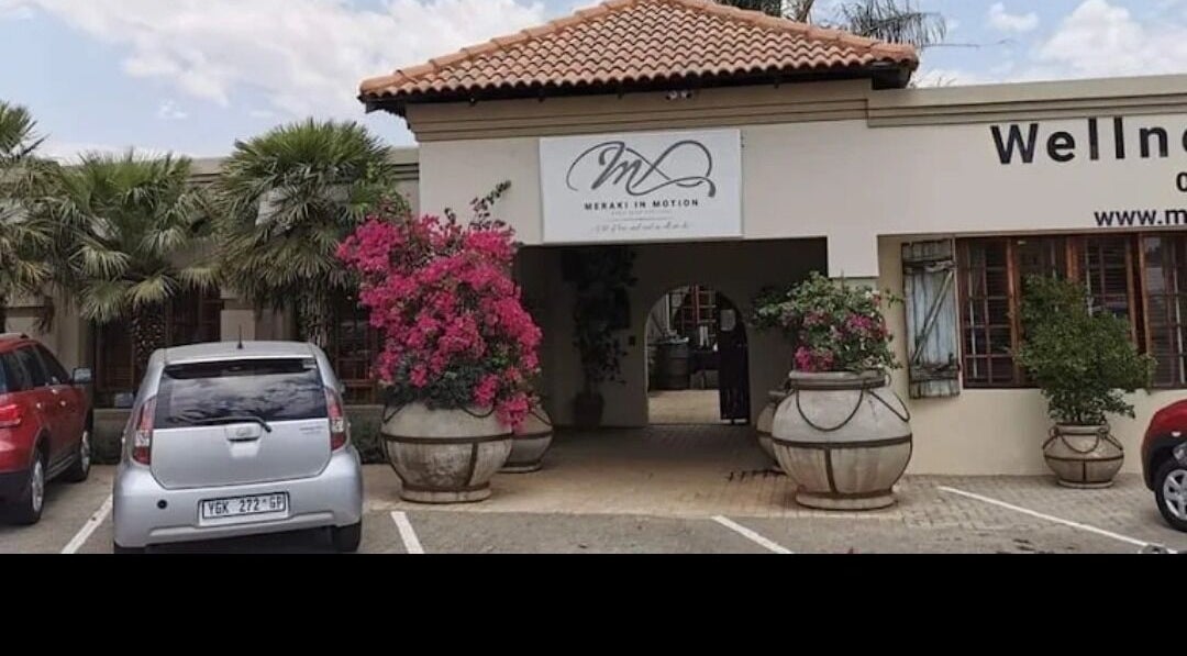 Entrance of Tvisha Aesthetics, Alberton, Gauteng, ZA featuring colorful floral displays.