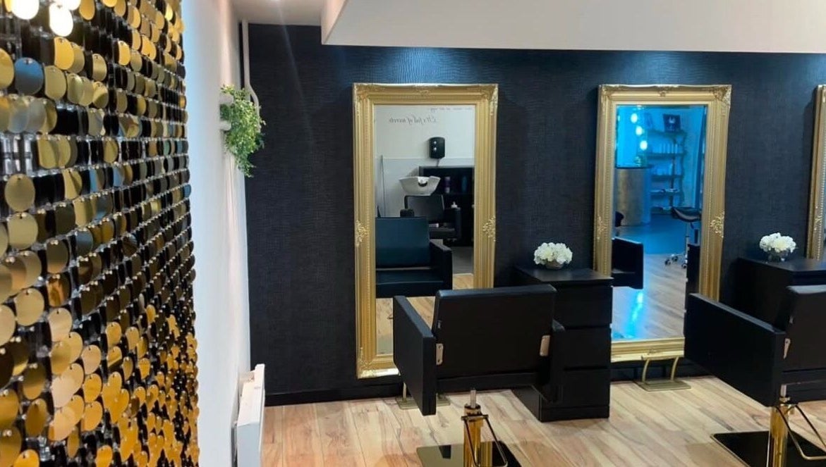 Elegant salon interior of Èlan by Ruby in Stornoway, Scotland, GB with mirrors, chairs, and stylish decor.