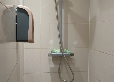 Modern shower setup at The Massage Therapy Centre, Wembley, England, GB with sleek tiles and spa essentials.