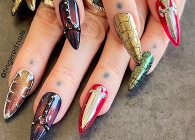Intricately designed nails at Fingered Nails, Brighton And Hove, England, GB showcasing vibrant artistic nail art.
