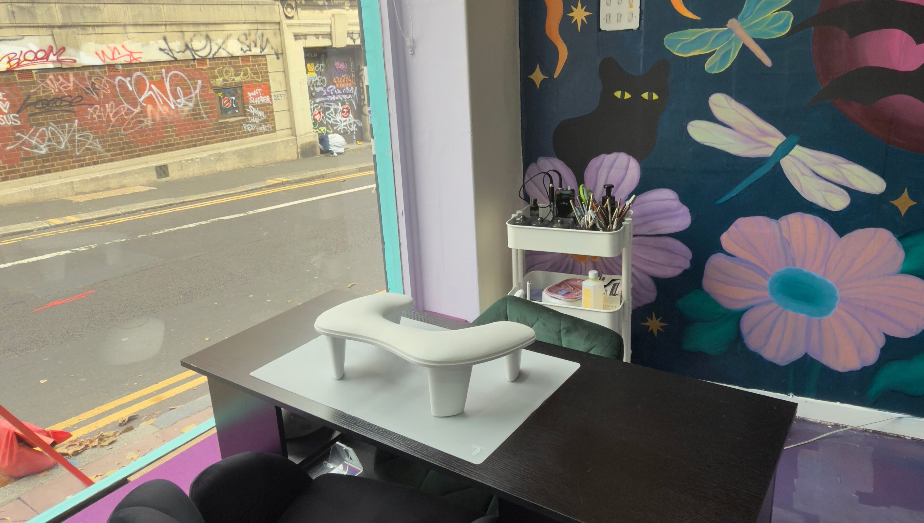 Nail salon interior at Fingered Nails in Brighton And Hove, England, GB with vibrant graffiti wall art.