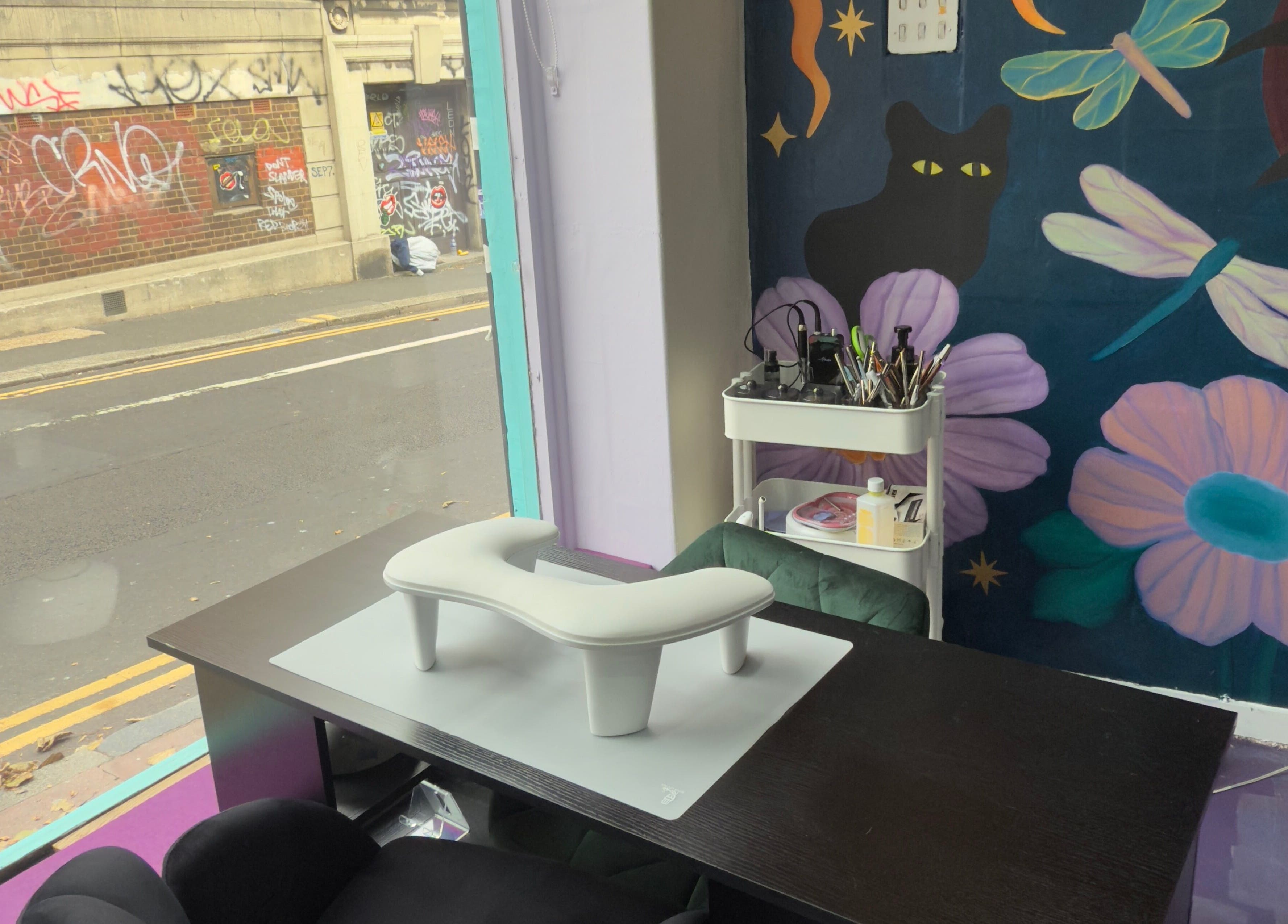 Nail salon interior at Fingered Nails in Brighton And Hove, England, GB with vibrant graffiti wall art.