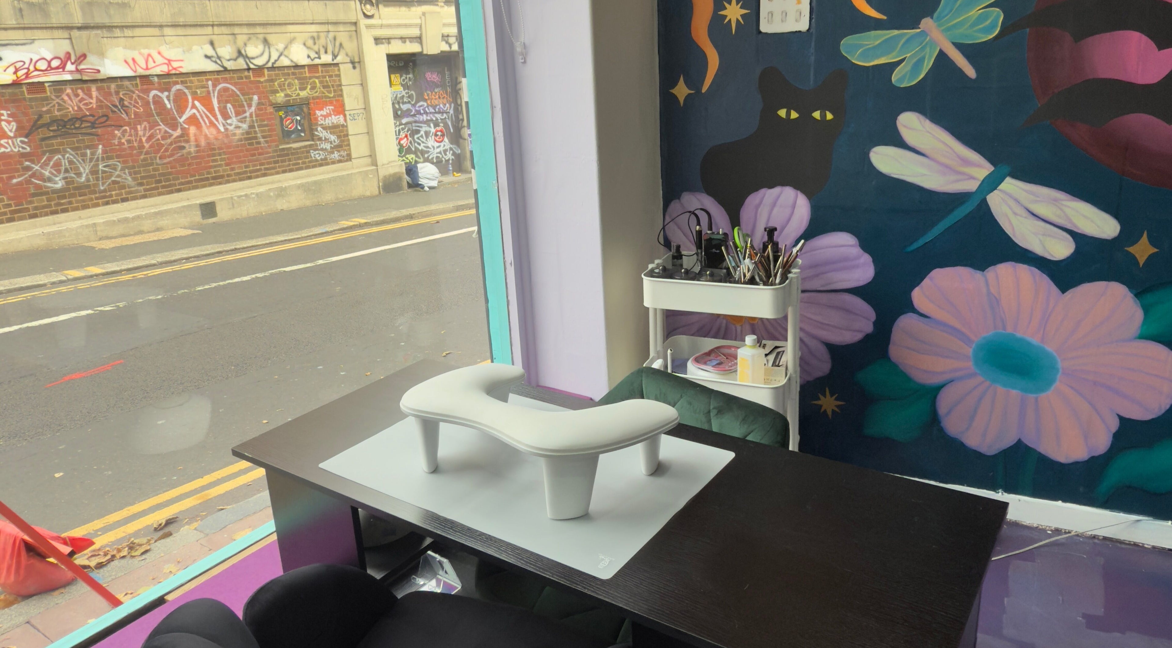 Nail salon interior at Fingered Nails in Brighton And Hove, England, GB with vibrant graffiti wall art.