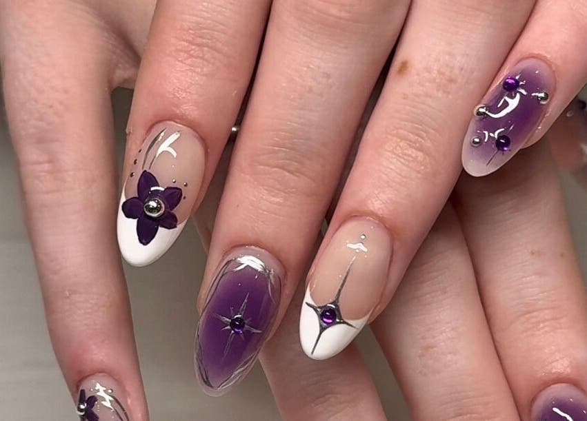 Elegant purple flower nail art at Fingered Nails in Brighton And Hove, England, GB.