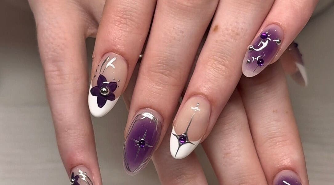 Elegant purple flower nail art at Fingered Nails in Brighton And Hove, England, GB.