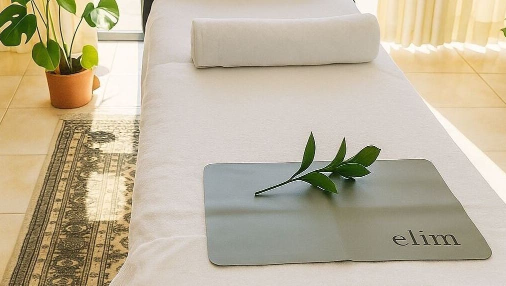 Relaxing massage table setup at Glow up in Cape Town, Western Cape, ZA with plant decor.