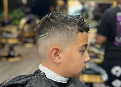 A stylish boy's fade haircut at Vic Fades, Santiago De Surco, Provincia De Lima, PE.