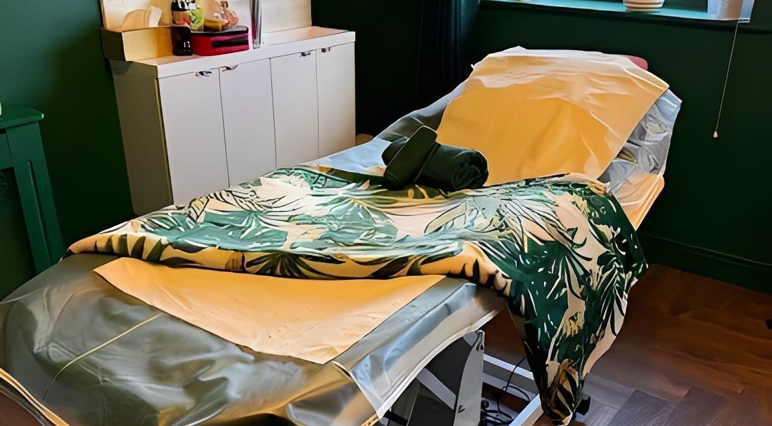 Serene massage bed at Pinks Beauty & Spa in Hitchin, England, GB, with tropical-themed decor.
