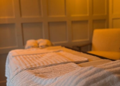 Relaxing massage room at Vicky Bradley PT & Massage, Deal, England, GB, featuring soft lighting and cozy decor.