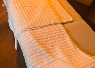 Cozy massage table at Vicky Bradley PT & Massage in Deal, England, GB, draped with a soft, white towel.