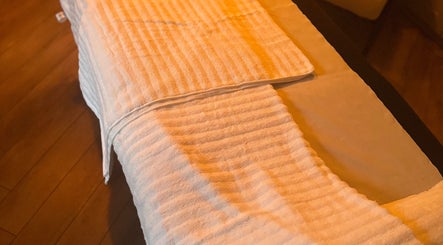 Cozy massage table at Vicky Bradley PT & Massage in Deal, England, GB, draped with a soft, white towel.