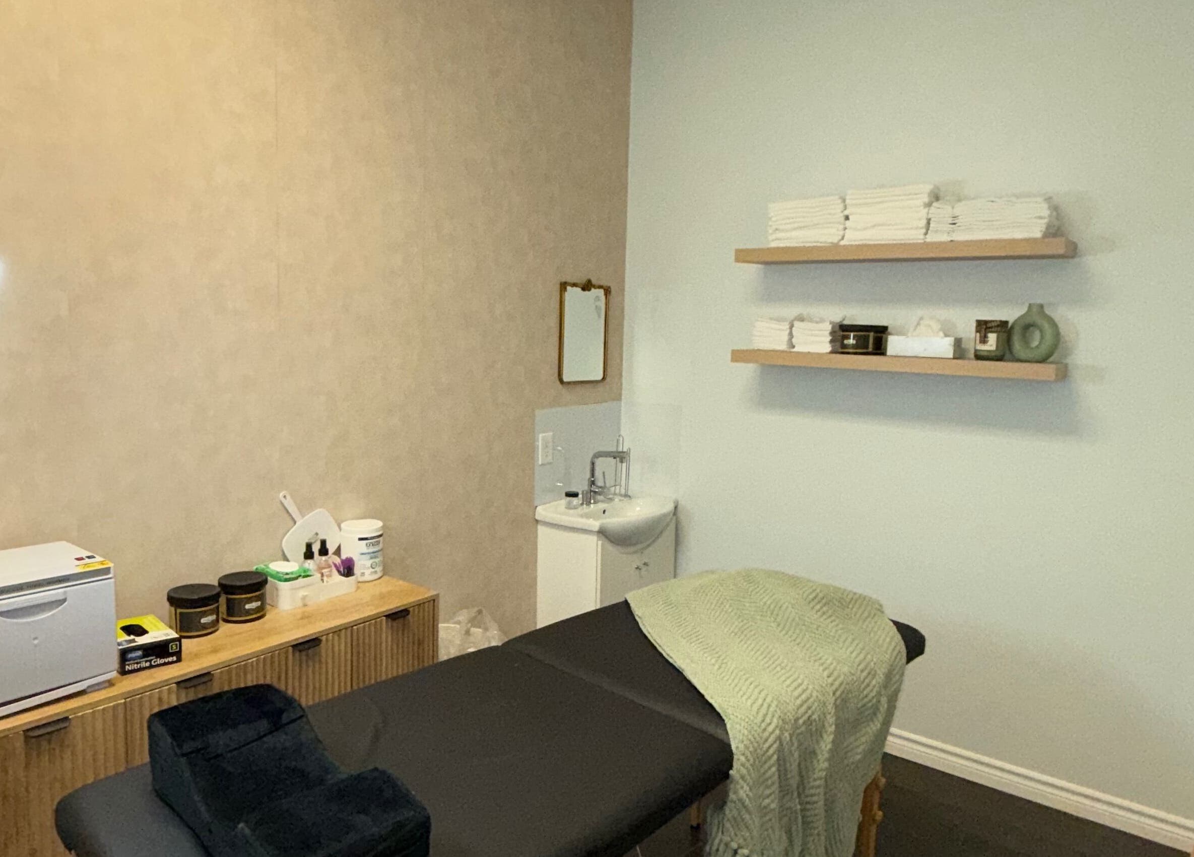 Treatment room at Skin Glow Studio x Sugar & Skin in London, Ontario, CA featuring a serene setup with massage table.