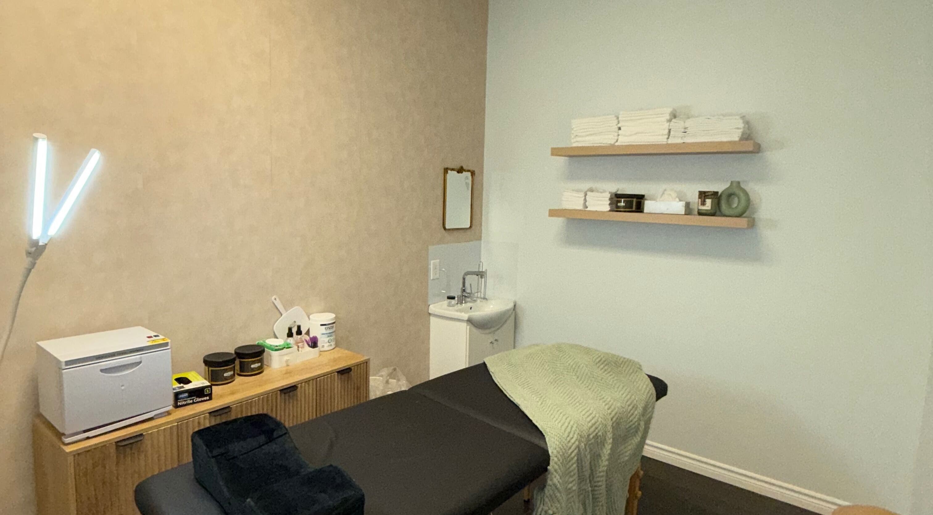 Treatment room at Skin Glow Studio x Sugar & Skin in London, Ontario, CA featuring a serene setup with massage table.