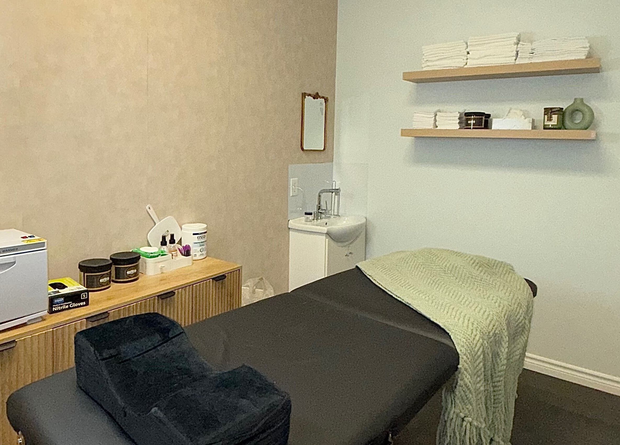 Cozy treatment room at Skin Glow Studio x Sugar & Skin in London, Ontario, CA, ready for a wellness session.