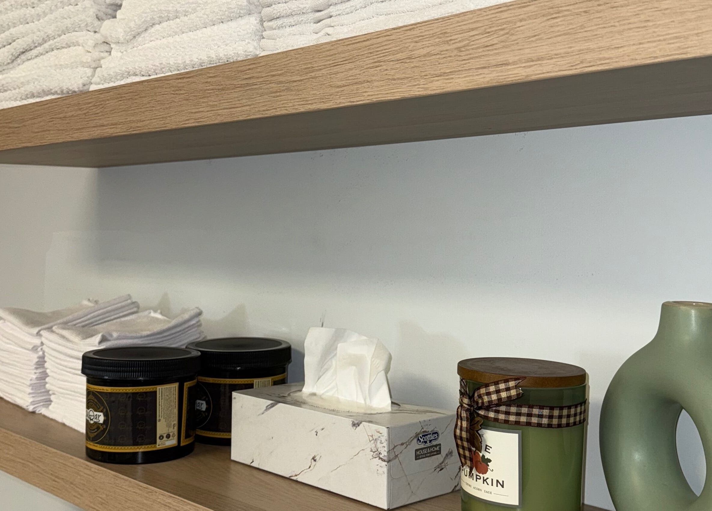 Organized shelves with towels and skincare at Skin Glow Studio x Sugar & Skin, London, Ontario, CA.