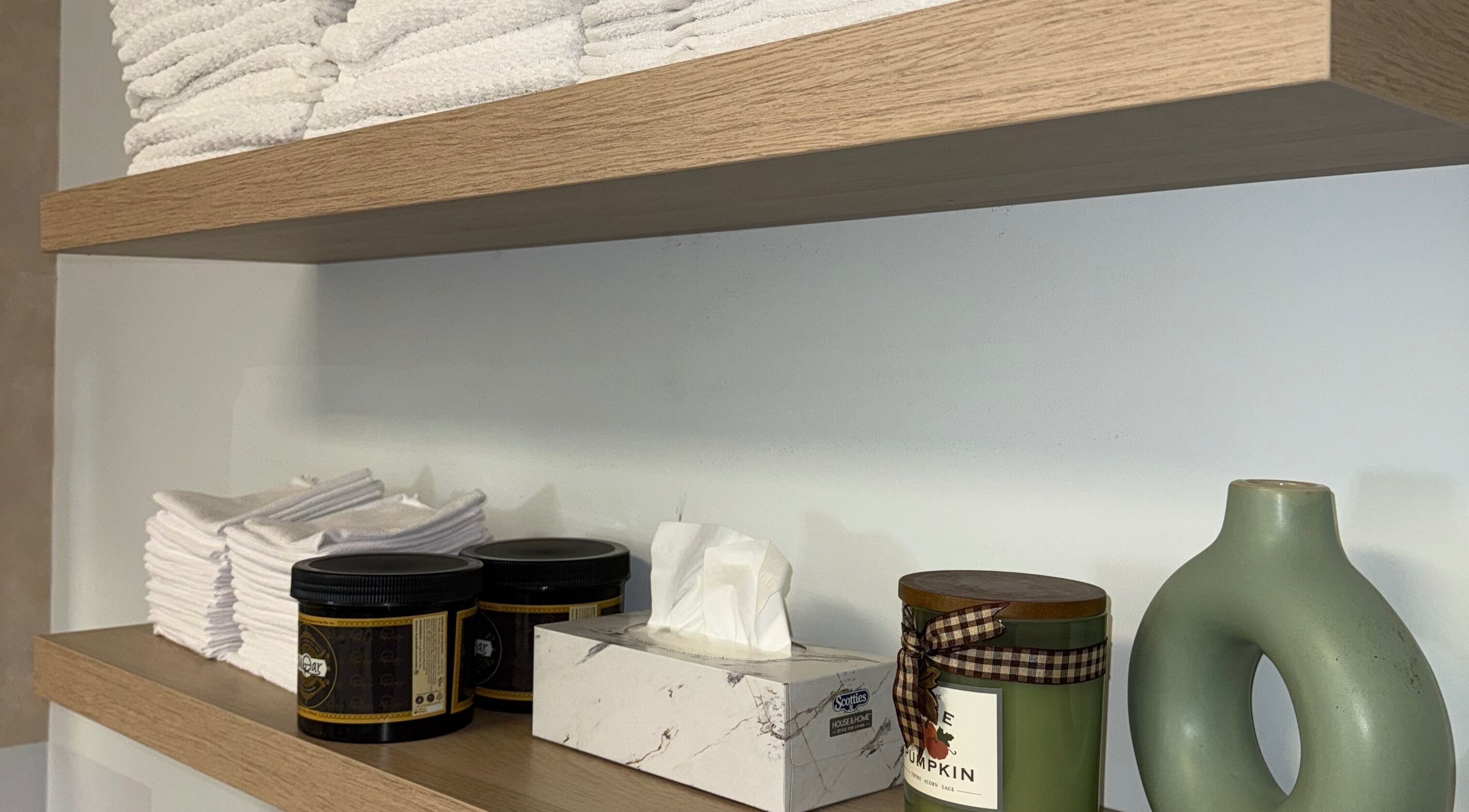 Organized shelves with towels and skincare at Skin Glow Studio x Sugar & Skin, London, Ontario, CA.