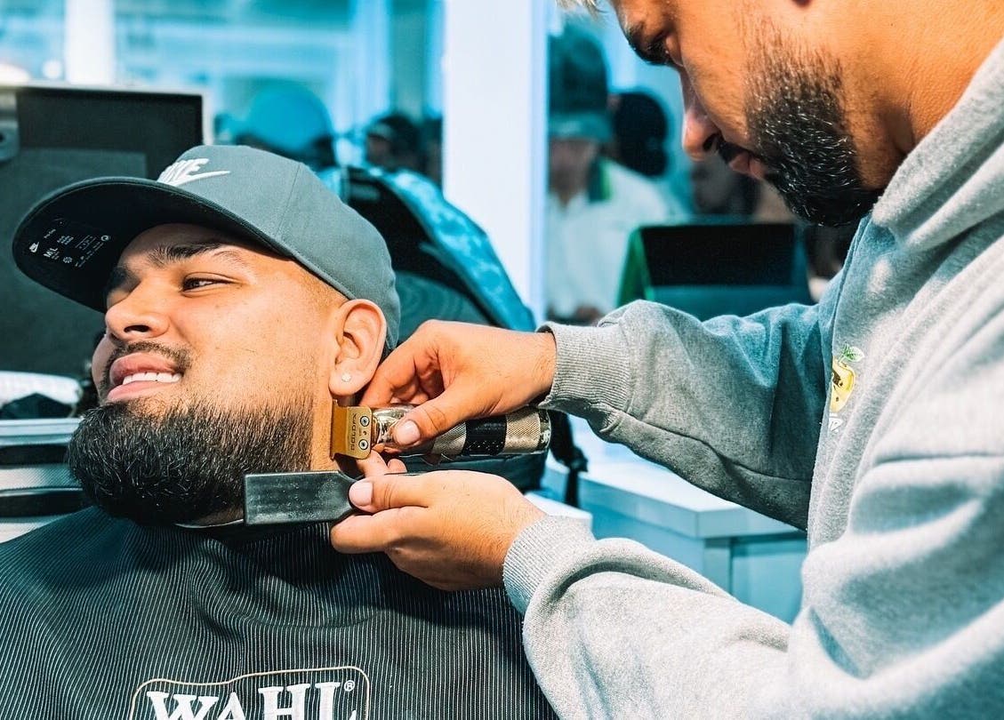 Barbero trabajando detalladamente en barba en CAPITAL CHAPINERO, Bogotá, Cundinamarca, CO.