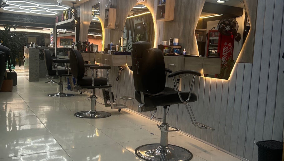 Stylish interior of American Barber Shop in Marinilla, Antioquia, CO with sleek chairs and illuminated mirrors.
