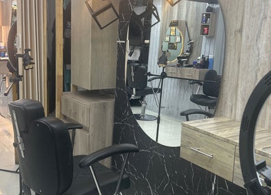 Modern interior of American Barber Shop in Marinilla, Antioquia, CO with sleek chairs and mirrors.