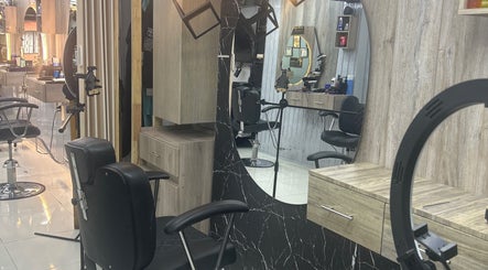 Modern interior of American Barber Shop in Marinilla, Antioquia, CO with sleek chairs and mirrors.
