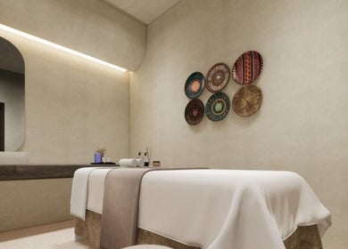 Elegant massage room at FOOT STEP, Sharjah, Sharjah, AE. Features cozy bed and artistic decor.