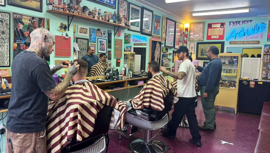 Dans Traditional Barbershop in Auckland, Auckland, NZ with barbers styling clients in a vintage setting.