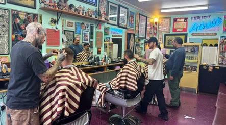 Dans Traditional Barbershop in Auckland, Auckland, NZ with barbers styling clients in a vintage setting.