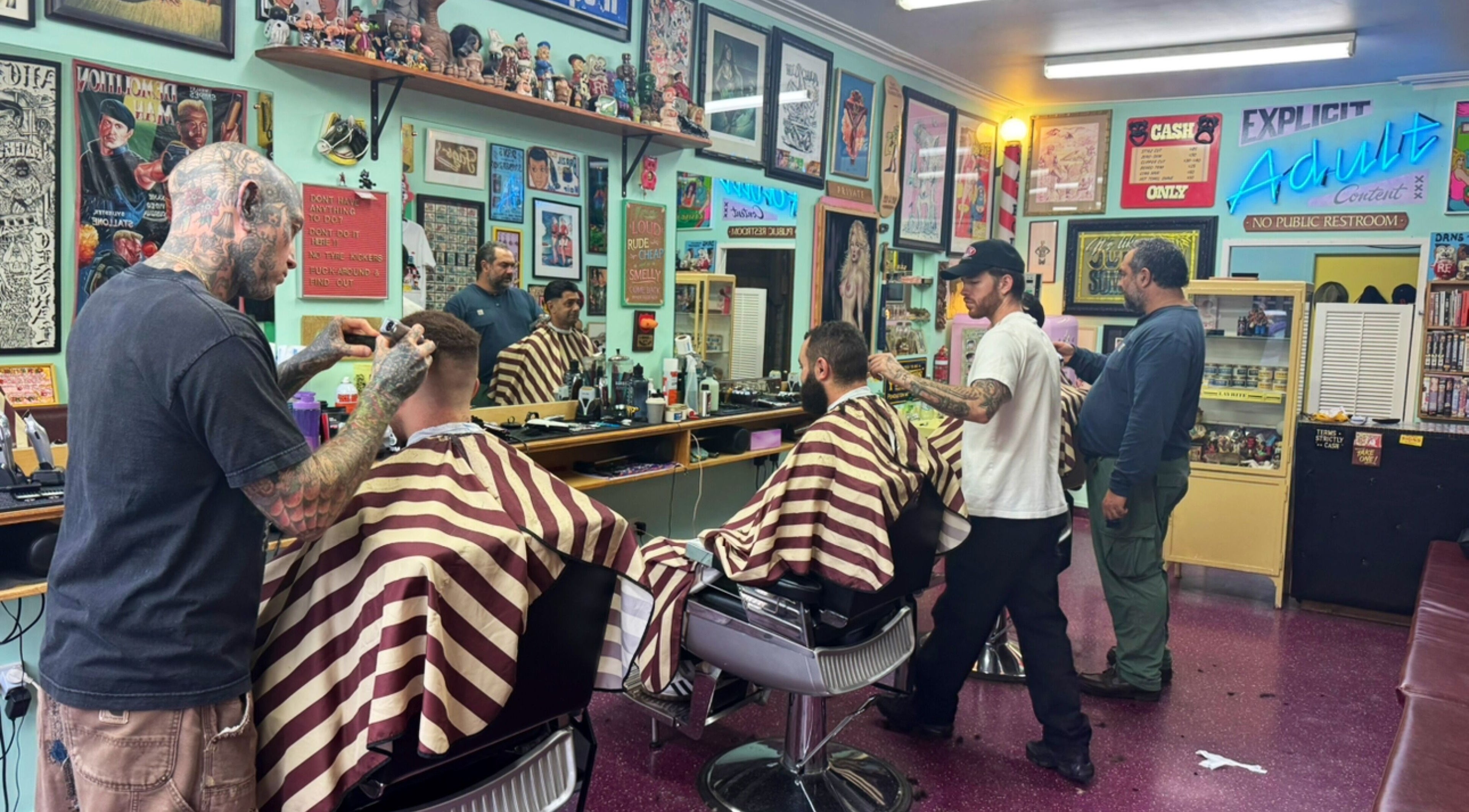 Dans Traditional Barbershop in Auckland, Auckland, NZ with barbers styling clients in a vintage setting.