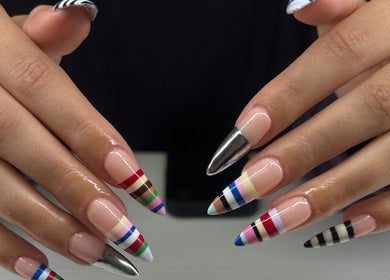 Colorful striped nail art at Adria Did My Nails in El Paso, Texas, US showcases expert craftsmanship.