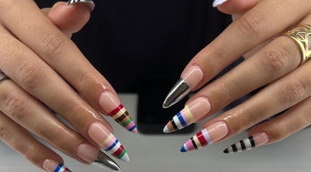 Colorful striped nail art at Adria Did My Nails in El Paso, Texas, US showcases expert craftsmanship.