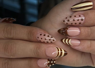 Stylish polka dot and striped nails designed at Adria Did My Nails in El Paso, Texas, US.