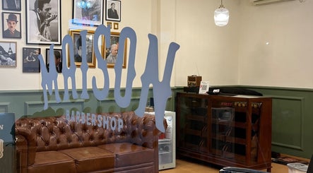Inside Maison Barbershop, Bali, Bali, ID features elegant decor and a comfortable leather sofa.